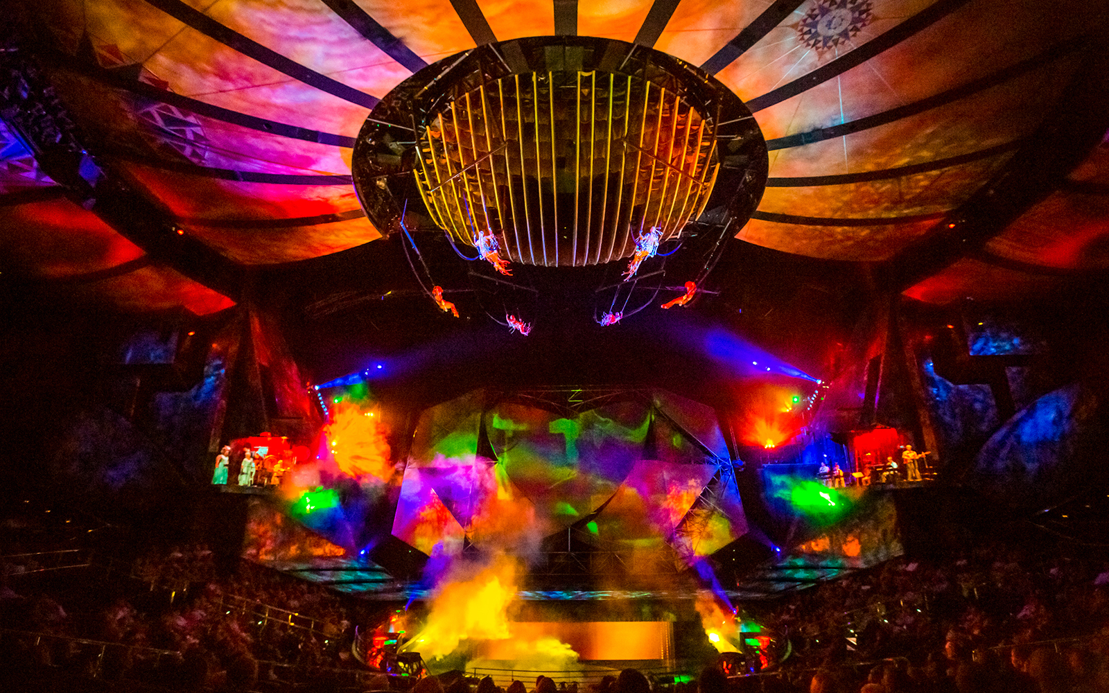 Acrobats performing under colorful lights at Mystère show in Las Vegas.