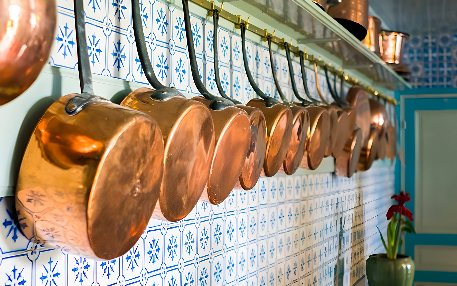 Copper pots hanging in Monet's kitchen at Giverny, France.