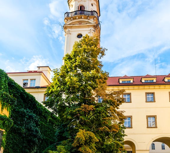 Klementinum courtyard with historic tower and ivy-covered walls in Prague.