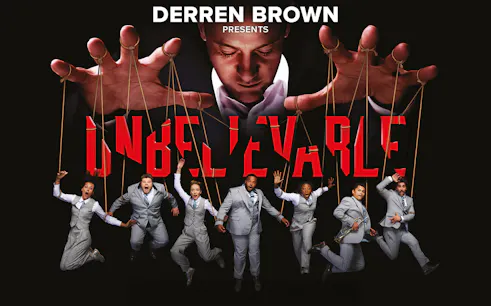 Illusionist controlling performers with strings in "Unbelievable" show.