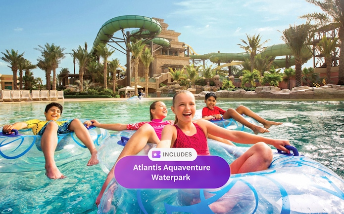 Children floating on tubes in the lazy river at Aquaventure Waterpark, Dubai.