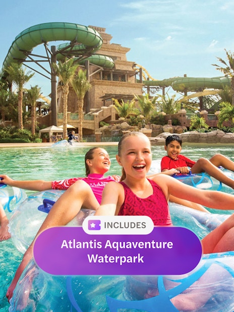 Children floating on tubes in the lazy river at Aquaventure Waterpark, Dubai.