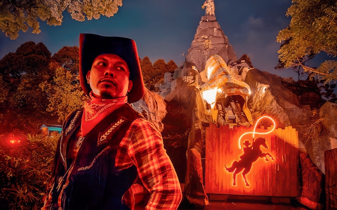 Park employee in cowboy attire at The Good The Bad and The Wild attraction.