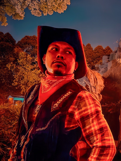 Park employee in cowboy attire at The Good The Bad and The Wild attraction.