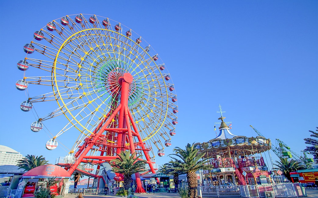 Ferris wheel and carousel at an amusement park in Kansai, Japan.