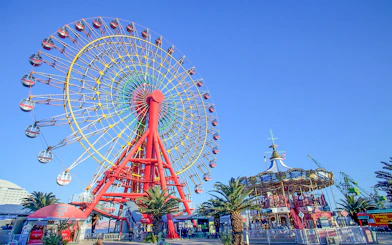 Ferris wheel and carousel at an amusement park in Kansai, Japan.