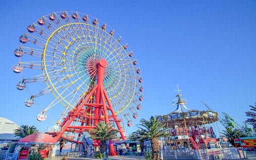 Ferris wheel and carousel at an amusement park in Kansai, Japan.