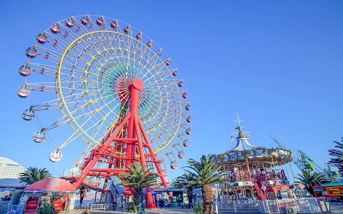 Ferris wheel and carousel at an amusement park in Kansai, Japan.