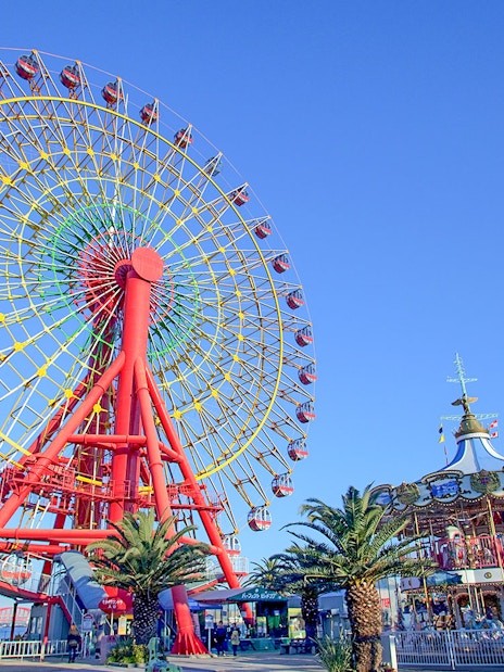 Ferris wheel and carousel at an amusement park in Kansai, Japan.
