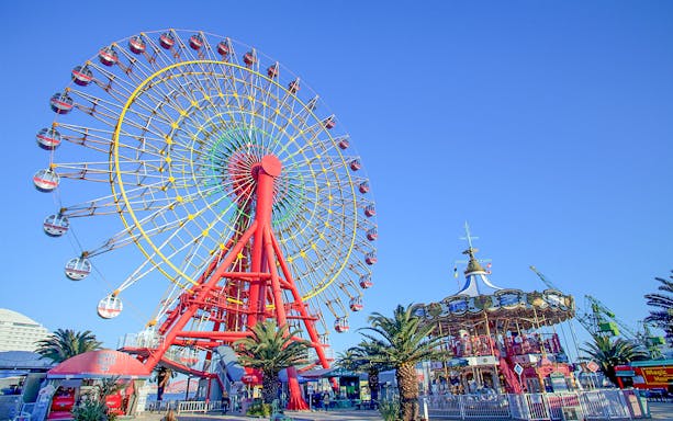 Ferris wheel and carousel at an amusement park in Kansai, Japan.