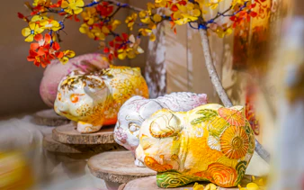Vietnamese piggy banks with floral designs at a painting workshop in Ho Chi Minh City.