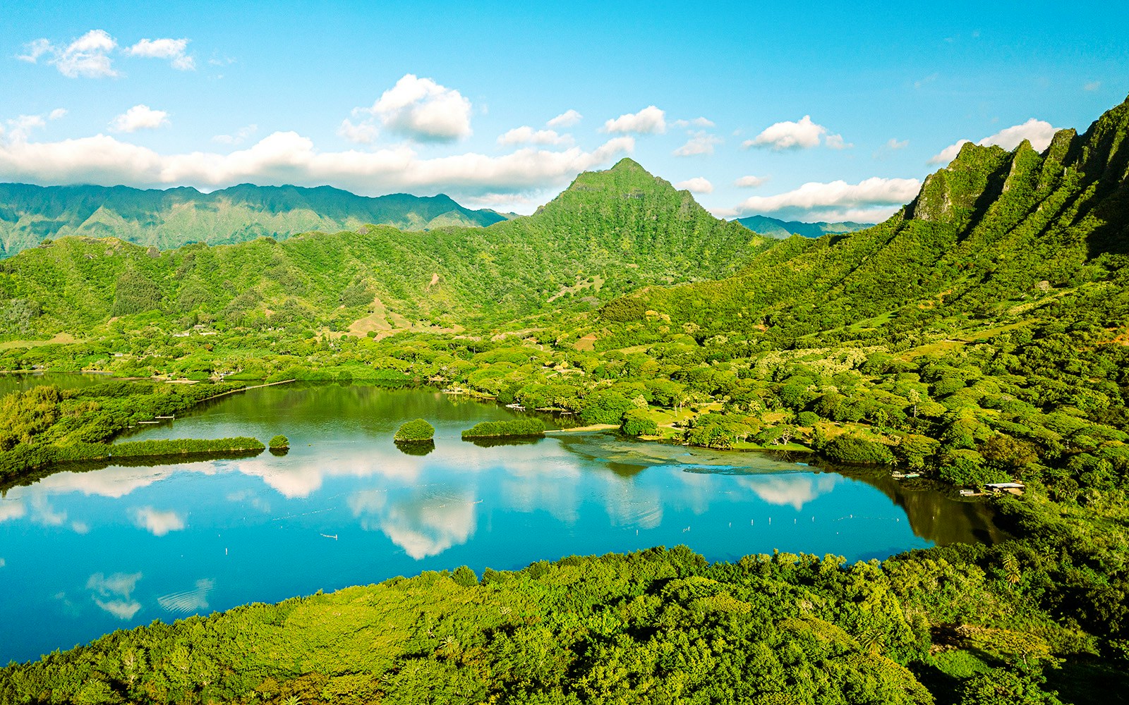 Aerial view of Moli'i fishponds with mountain reflections in Hawaii.