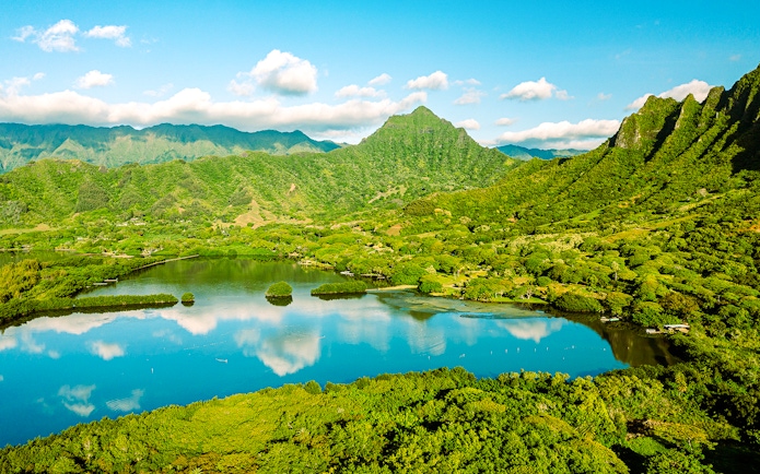 Aerial view of Moli'i fishponds with mountain reflections in Hawaii.