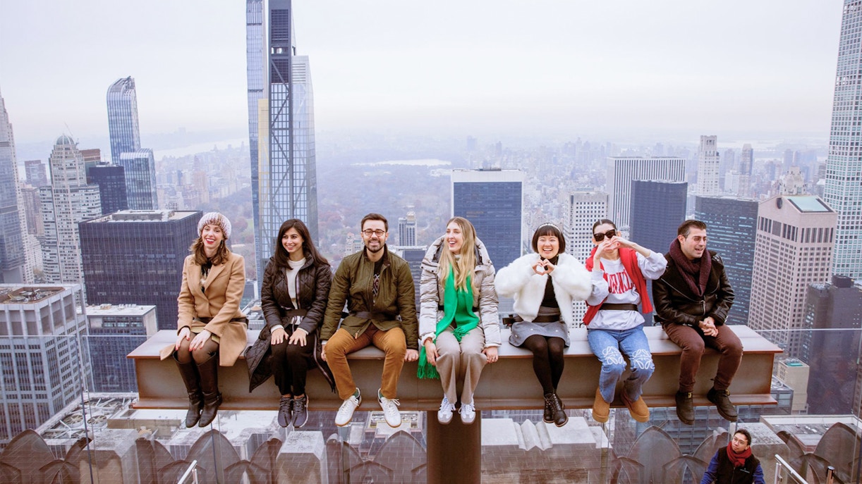 Workers balancing on a steel beam during construction at Rockefeller Center, New York.