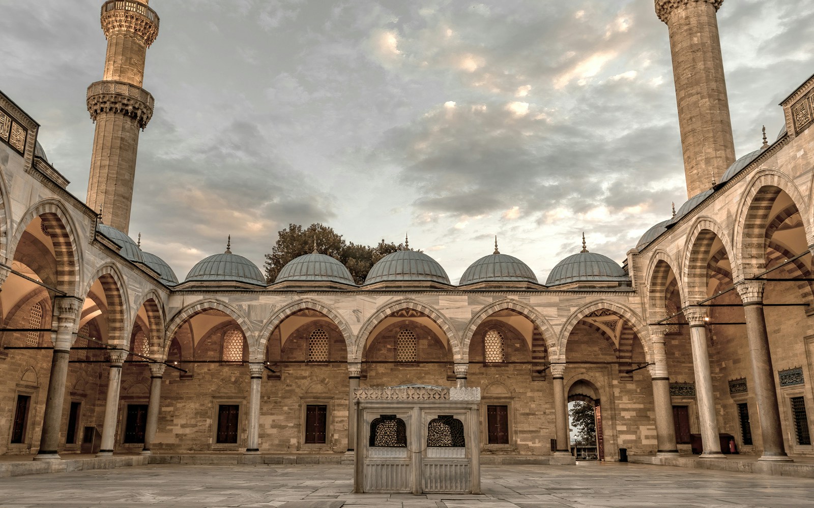 Suleymaniye Mosque courtyard with arches and domes during guided tour in Istanbul.