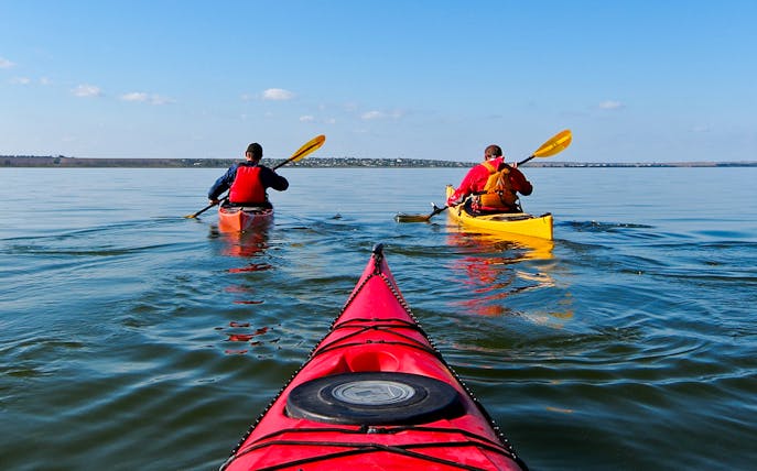 Kayakers paddling in Ieranto Bay during a 4-hour tour.