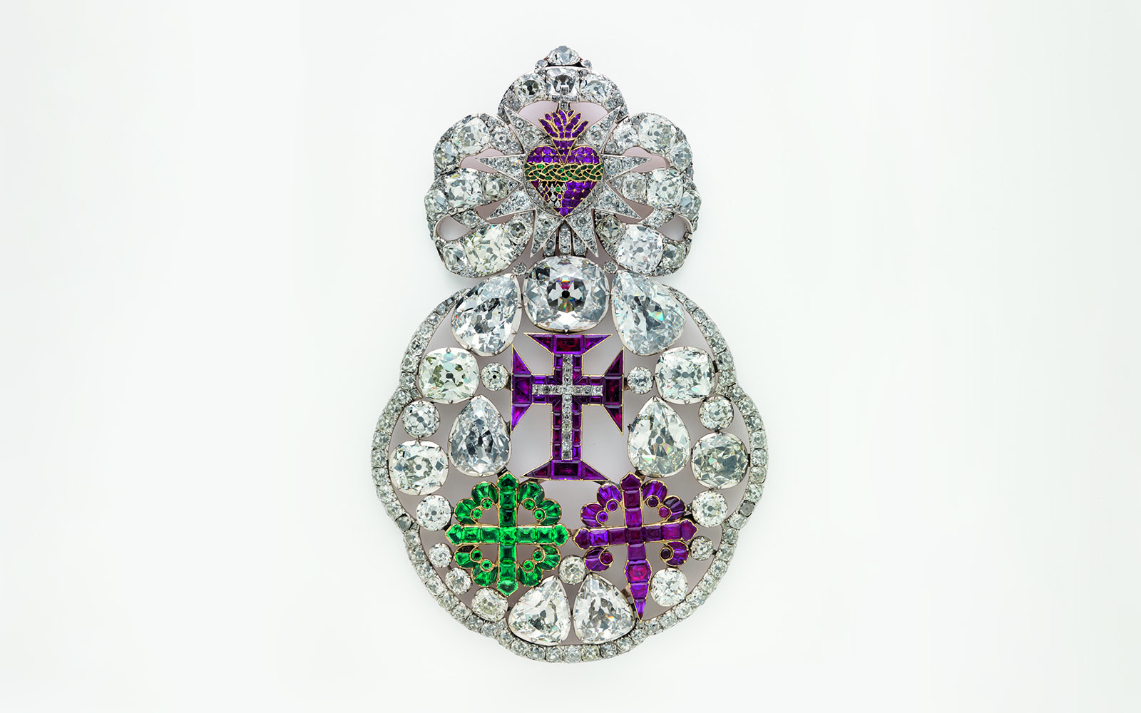 Ornate jeweled brooch with diamonds and colored gems at Royal Treasure Museum.