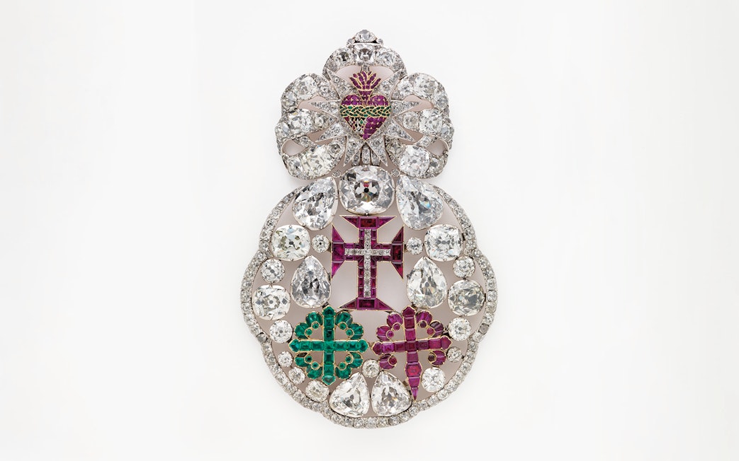 Ornate jeweled brooch with diamonds and colored gems at Royal Treasure Museum.