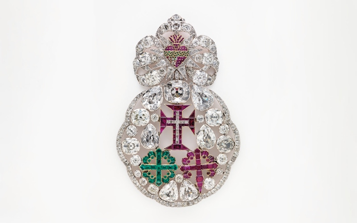 Ornate jeweled brooch with diamonds and colored gems at Royal Treasure Museum.