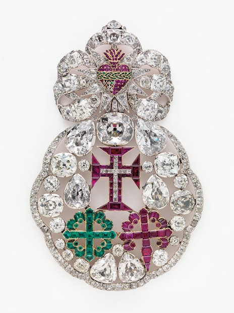 Ornate jeweled brooch with diamonds and colored gems at Royal Treasure Museum.