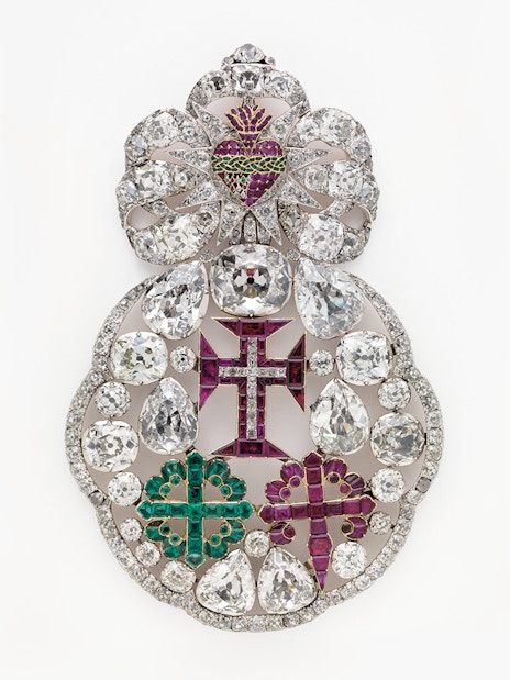 Ornate jeweled brooch with diamonds and colored gems at Royal Treasure Museum.