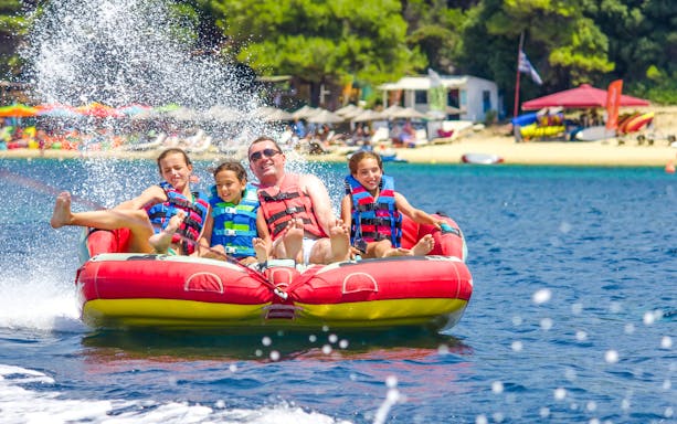 Family on a donut tube water ride in Dubai.