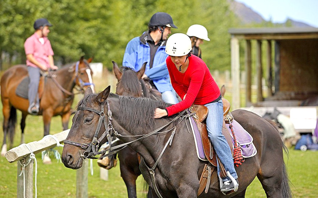 Horse riders preparing for a trek at Walter Peak, Queenstown.