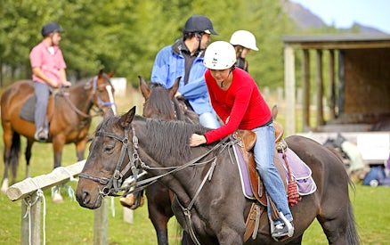 Horse riders preparing for a trek at Walter Peak, Queenstown.