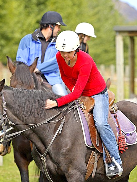 Horse riders preparing for a trek at Walter Peak, Queenstown.
