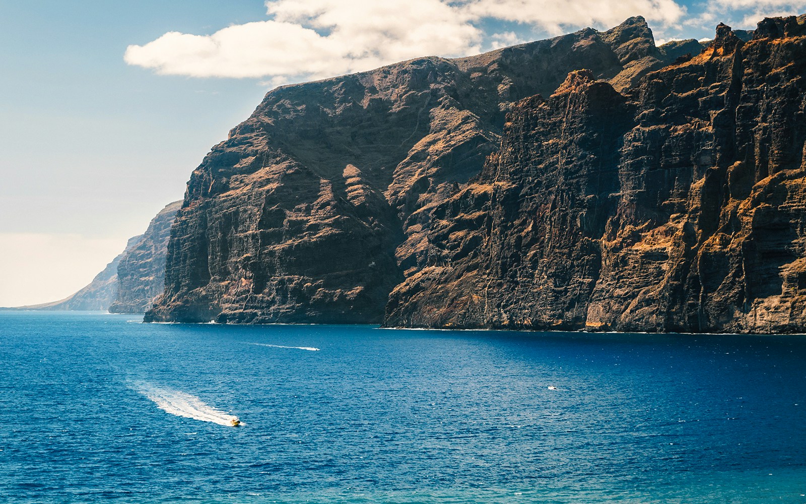 Boat sailing near Los Gigantes cliffs, Tenerife, Canary Islands, Spain.