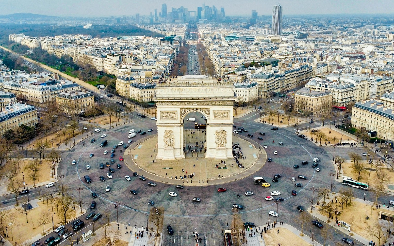 Drone view of Arc de Triomphe and surrounding streets in Paris, France.