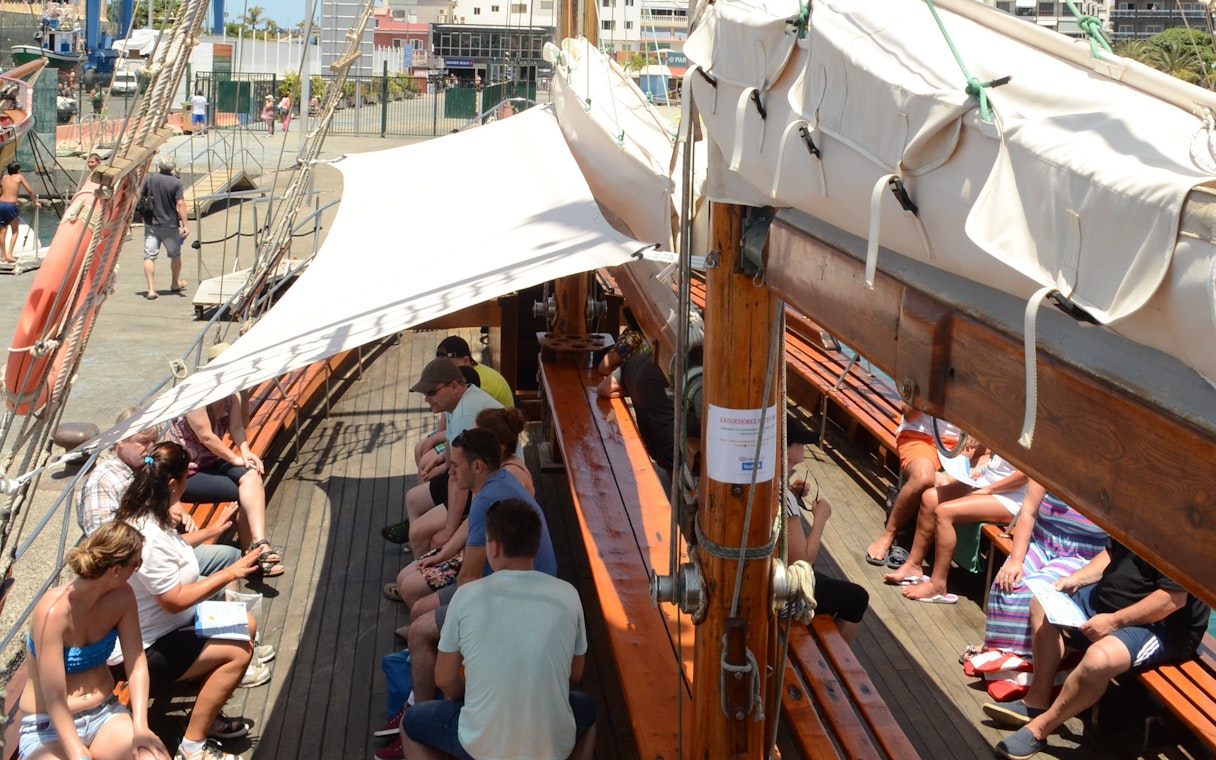 Tourists seated on Peter Pan Pirate boat in Tenerife, preparing for whale and dolphin watching.
