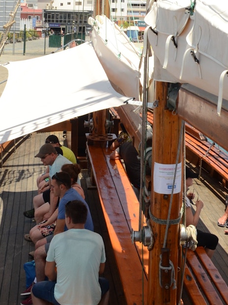 Tourists seated on Peter Pan Pirate boat in Tenerife, preparing for whale and dolphin watching.