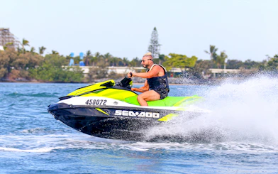Person riding a jet ski on open water during a Jet Ski & Parasail Experience.