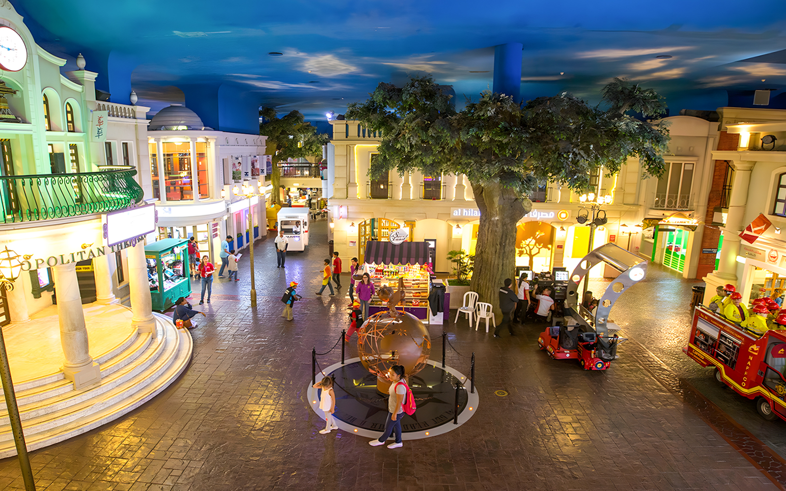 KidZania Abu Dhabi streets with children exploring interactive shops and activities.