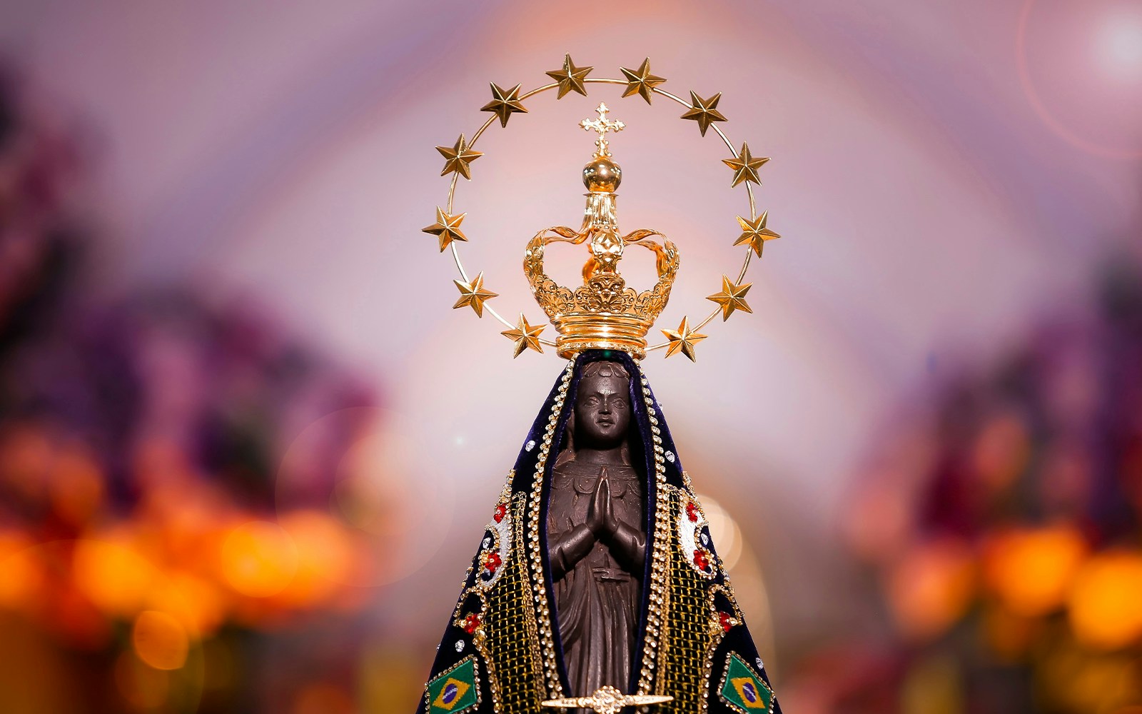Lady of Aparecida statue in Aparecida, Brazil, with surrounding basilica architecture.