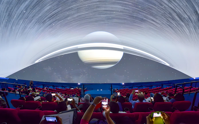 Visitors watching a space projection at Omni Theatre, Singapore.