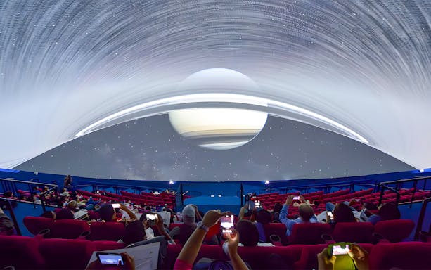 Visitors watching a space projection at Omni Theatre, Singapore.