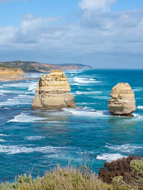 Twelve Apostles rock formations along Great Ocean Road, Australia, with ocean waves.