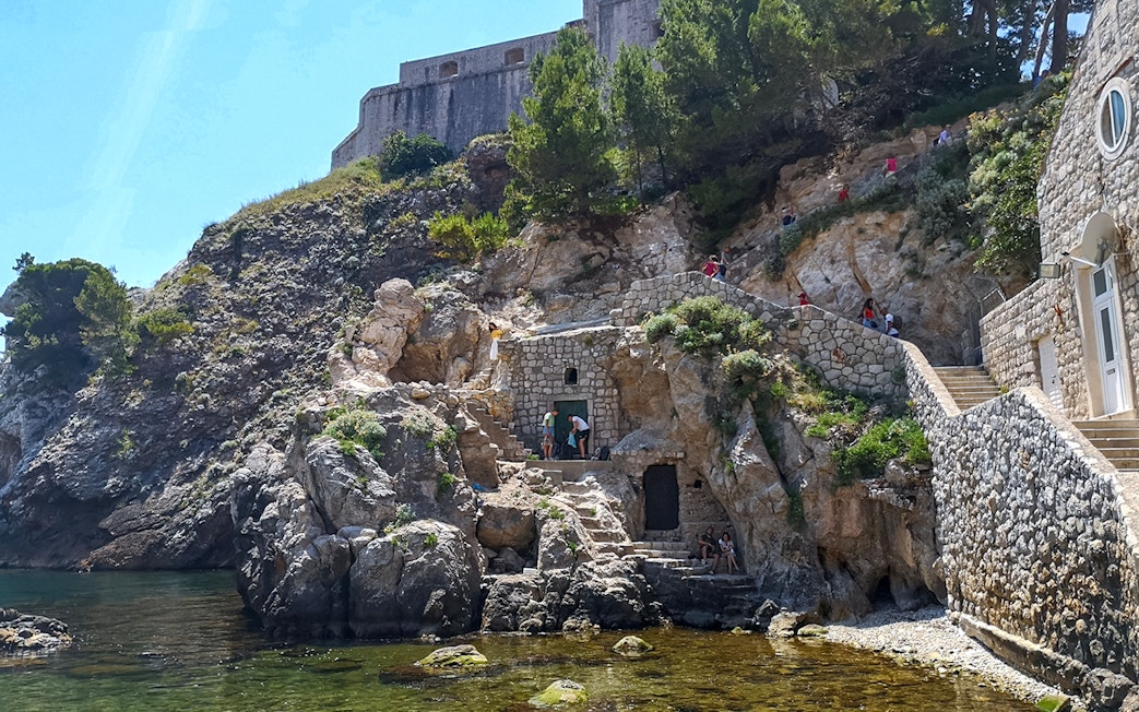 Guests exploring Lovrijenac Fort's rocky path in Dubrovnik, Croatia.