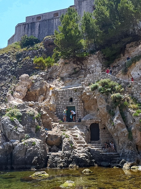 Guests exploring Lovrijenac Fort's rocky path in Dubrovnik, Croatia.
