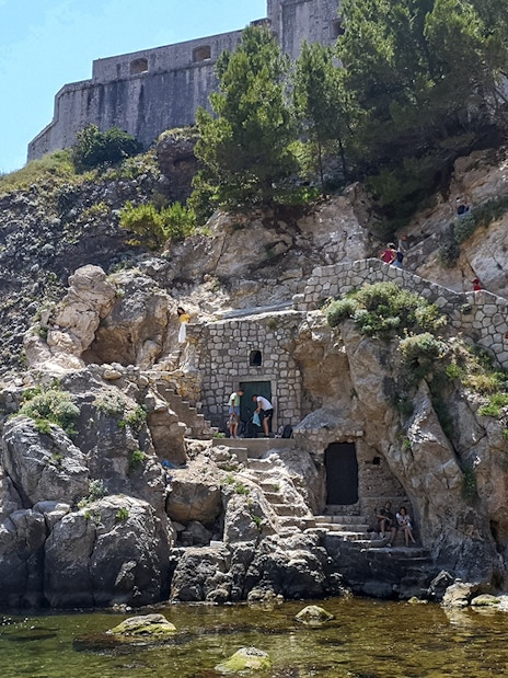 Guests exploring Lovrijenac Fort's rocky path in Dubrovnik, Croatia.