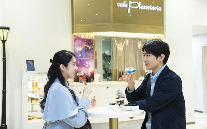 Visitors enjoying desserts at Cafe Planetaria inside Konica Minolta Planetaria TOKYO Ginza.