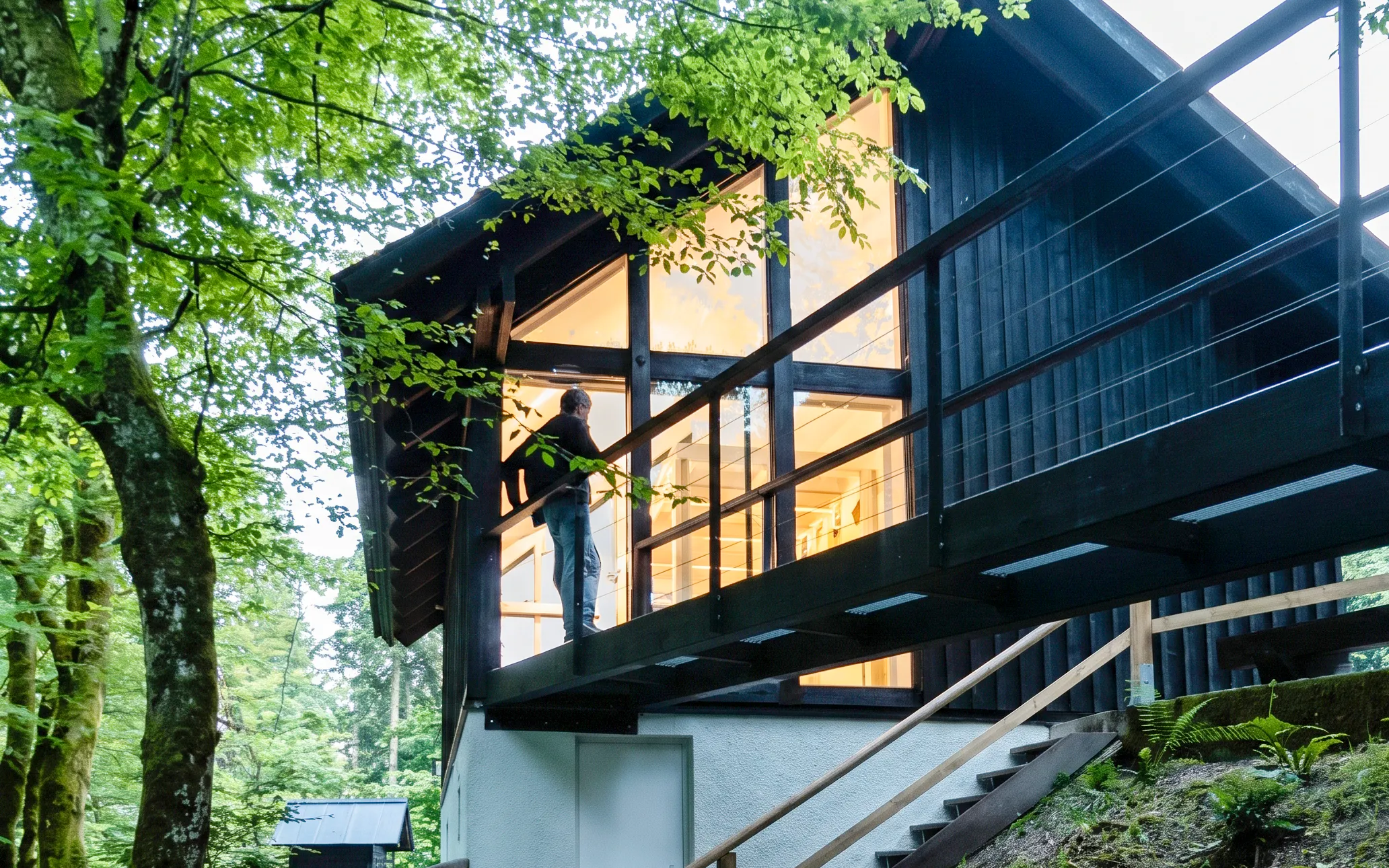 Modern cabin surrounded by lush forest near Vintgar Gorge, Slovenia.