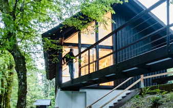 Modern cabin surrounded by lush forest near Vintgar Gorge, Slovenia.