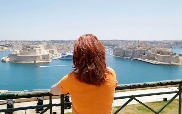 Person overlooking Valletta harbor during 3 Cities Tour in Malta.