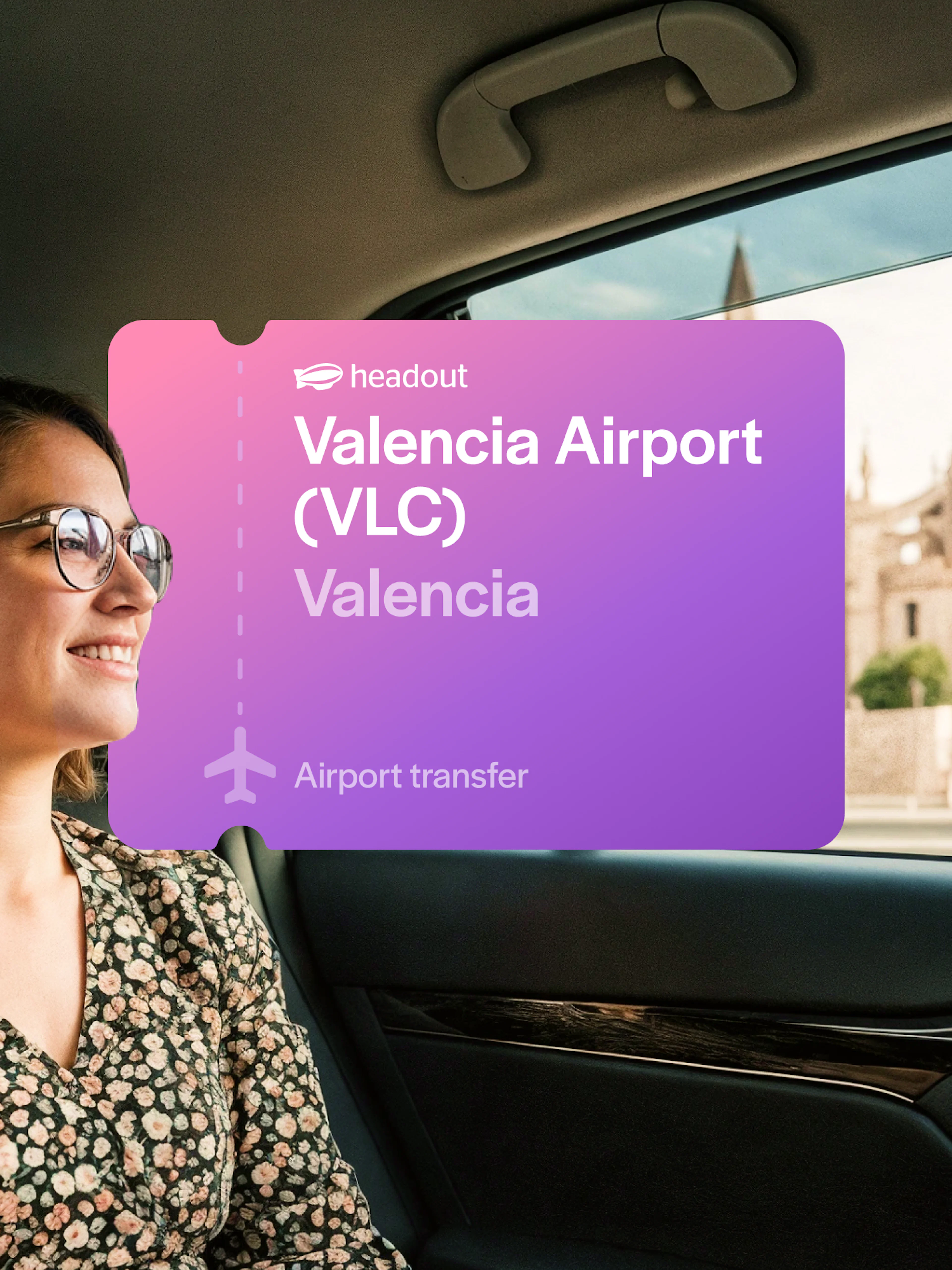 Woman in private transfer car with Valencia Cathedral view.