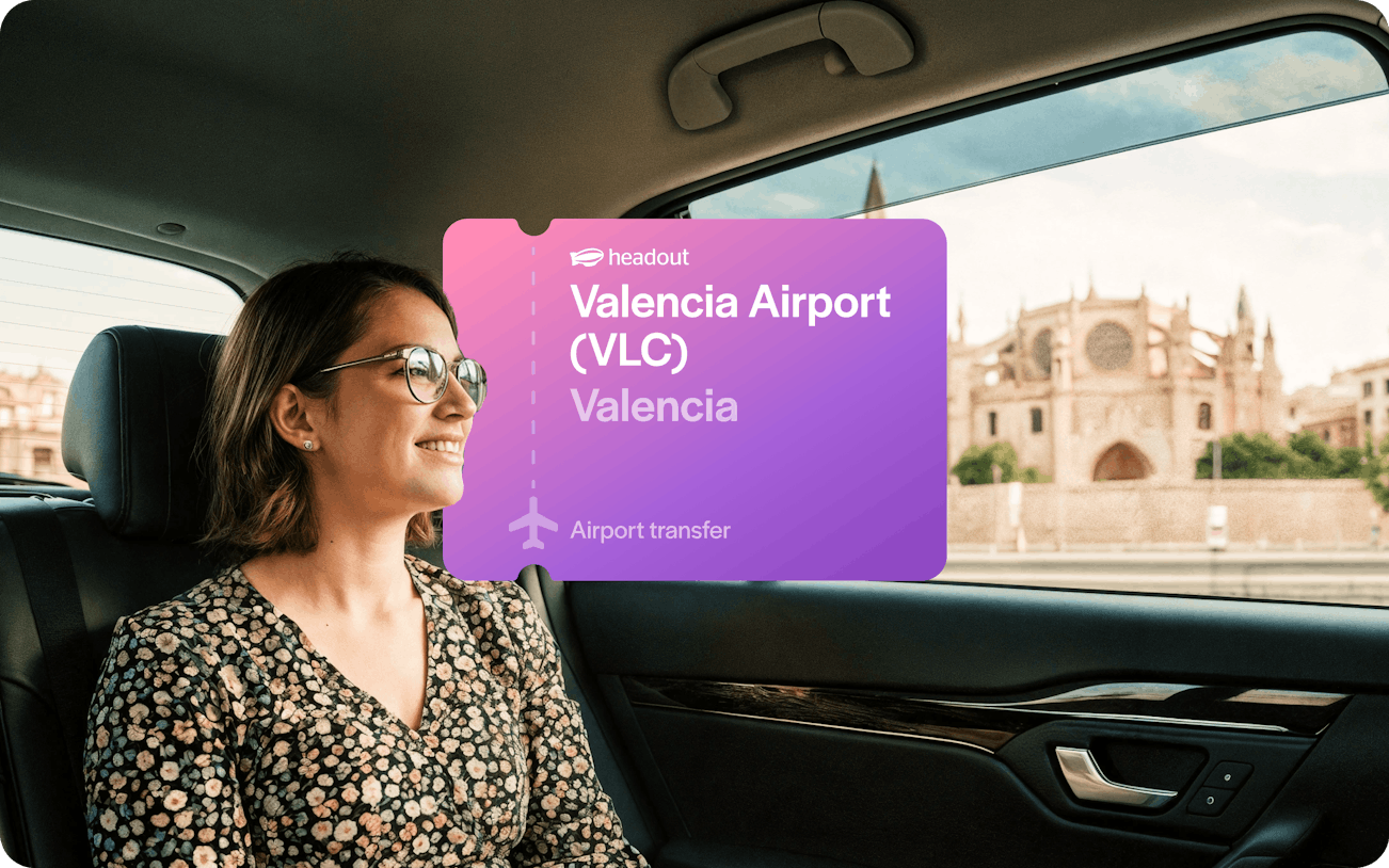 Woman in private transfer car with Valencia Cathedral view.