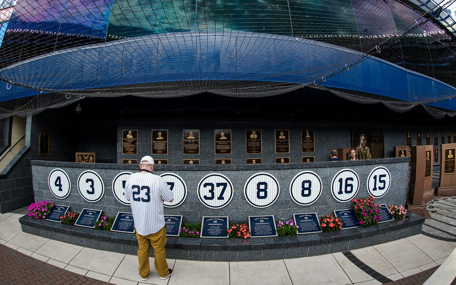 Yankees Monument Park with retired numbers and plaques at Yankee Stadium.