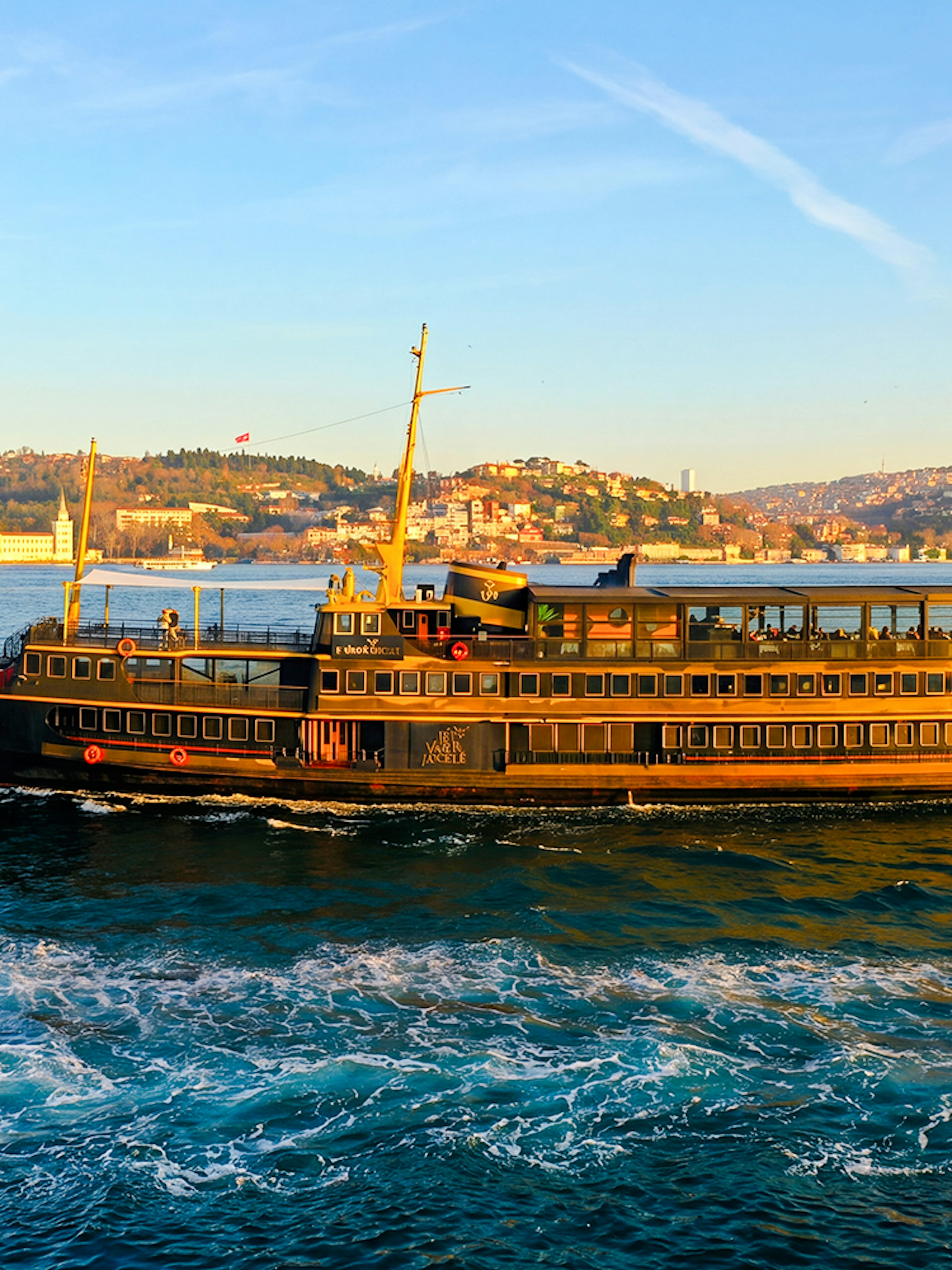 Le Vapeur Magique cruising on the Bosphorus with Istanbul skyline in the background.